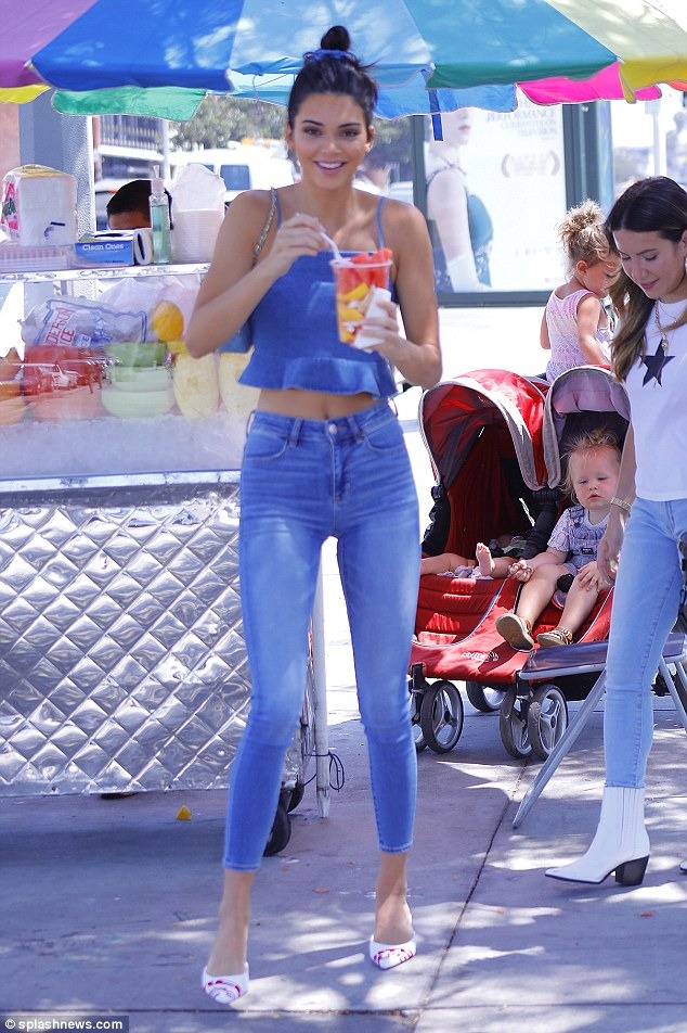 Kendall Jenner flashes her taut abs and slender pins in flirty double denim ensemble… after admitting she was ‘misrepresented’ when boasting about her ‘super selective’ career