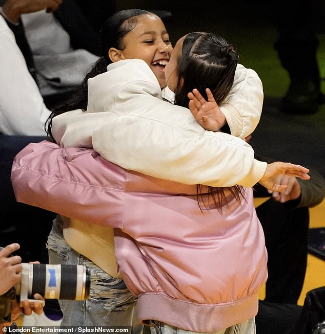 Kim Kardashian’s stylish daughter North West gives her pal a hug as they watch the Nuggets beat the Lakers in Los Angeles