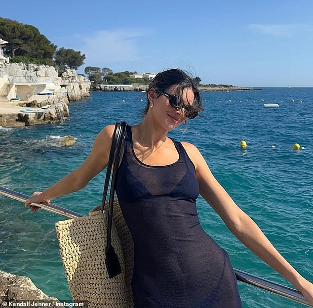 Kendall Jenner shows off her sculpted form in a sheer dress while soaking up the sun during a coastal getaway