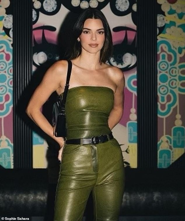 Kendall Jenner models a green tube top and matching slacks as she visits David Grutman’s newly opened Komodo restaurant in Dallas