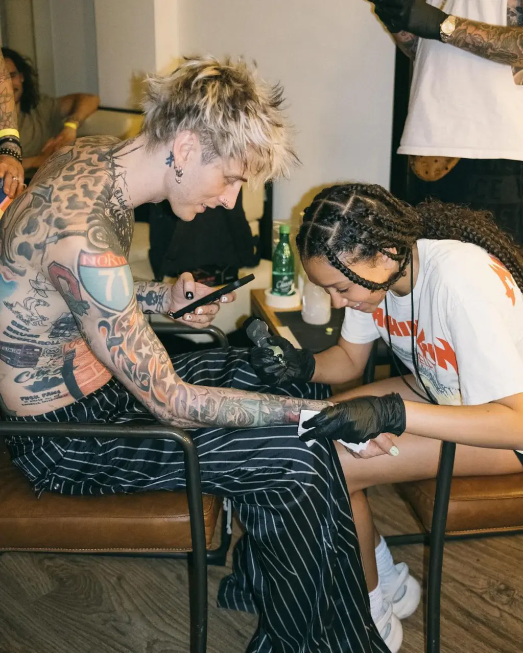 Machine Gun Kelly lets daughter Casie, 13, give him a tattoo backstage at Hellfest