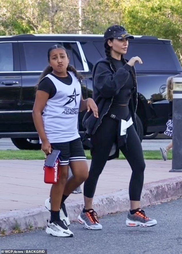 Fresh-faced Kim Kardashian cuts a casual figure in skintight black sportswear as she takes daughter North, 10, to basketball practice