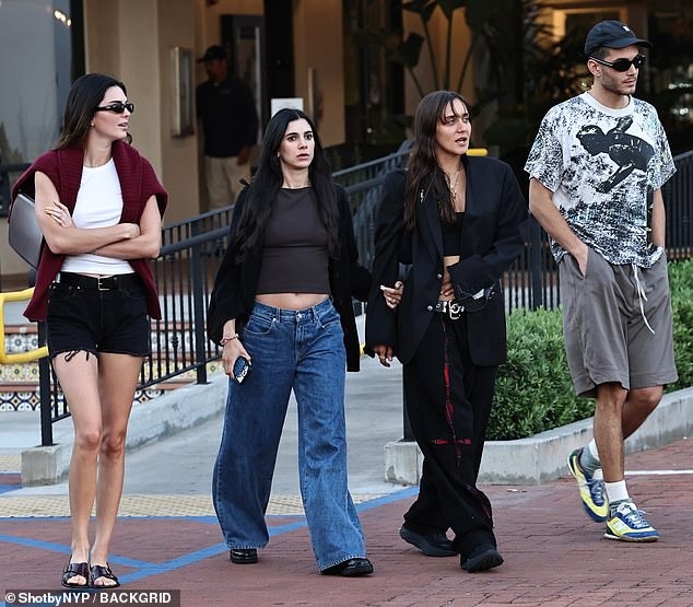 Kendall Jenner displays her endless legs in cutoff black shorts while out with friends in Malibu