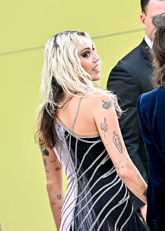 Miley Cyrus Brings Edgy Glamour in Ombre Gown With Sinuous Silver Chains to Versace Fall 2023 Fashion Show in Los Angeles