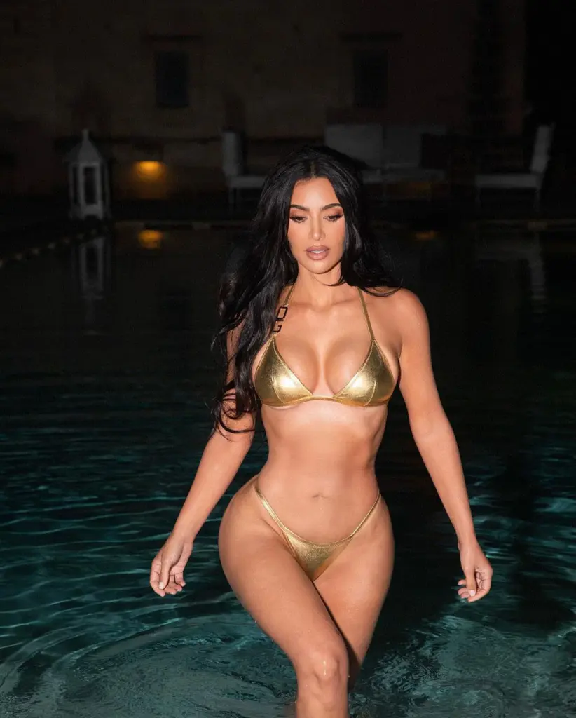 Kim Kardashian bikes in a teeny tiny gold ʙικιɴι in Sєxy ‘night swim’ snaps