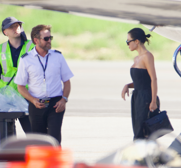 CLOSE CALL Kim Kardashian spills out of tight black corset as she steps off her $150M private jet with North West after Japan trip