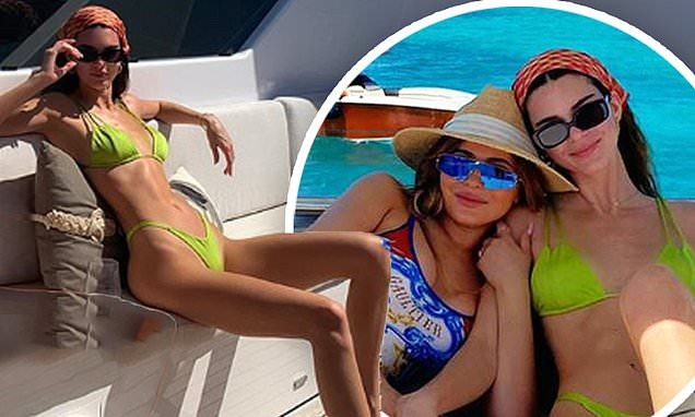 Kendall Jenner makes a splash in neon green ʙικιɴι as she curls up next to sister Kylie aboard boat during girls’ getaway to the Bahamas