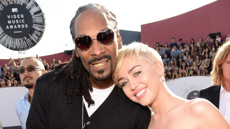 The Secret Miley Cyrus And Snoop Dogg Once Kept From Her Late Grandmother   Read More: https://www.thelist.com/1393337/miley-cyrus-snoop-dogg-kept-secret-from-grandmother/