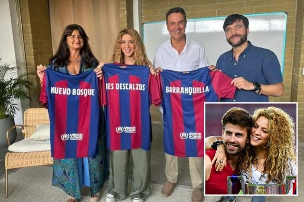 SHAK IT OFF Shakira holds up Barcelona shirt as she poses with staff from Gerard Pique’s former club a year on from split