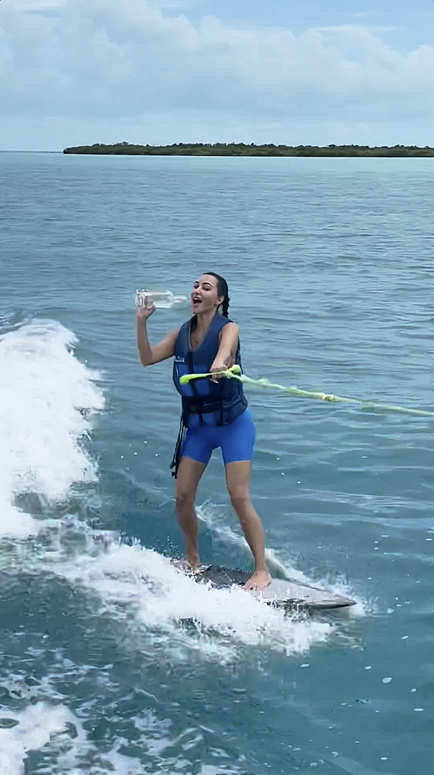 WILD RIDE Kim Kardashian flies off wakesurf board after appearing to chug tequila as she rides behind racing speed boat