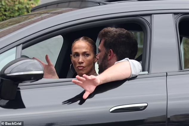 Jennifer Lopez looks tense as she listens intently to husband Ben Affleck as he chauffeurs her around LA