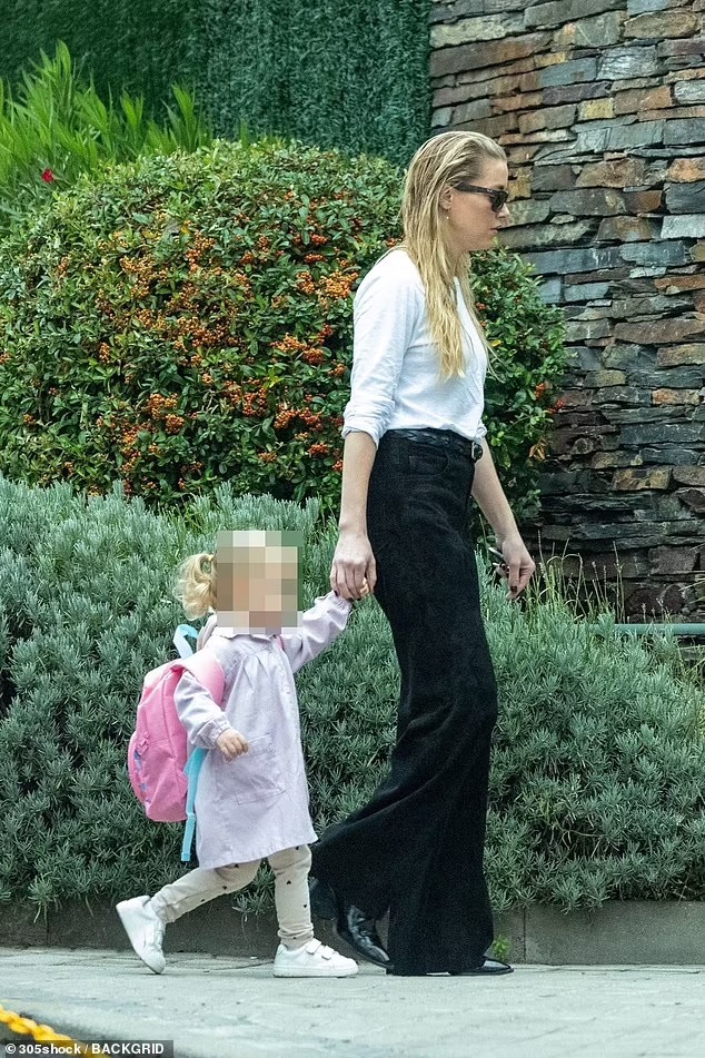 Amber Heard sweetly holds hands with daughter Oonagh, two, while seen WITHOUT crutches after injury – as they enjoy new life in Madrid amid bombshell claims about Aquaman 2