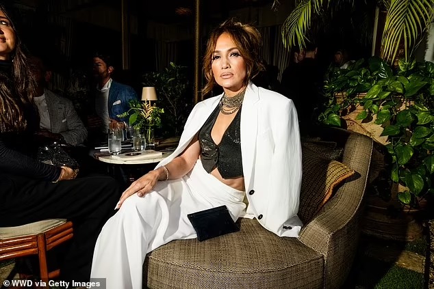 Jennifer Lopez puts on a glamorous display in cropped sequined vest and white satin maxi skirt at the star-studded Brunello Cucinelli soiree in Los Angeles