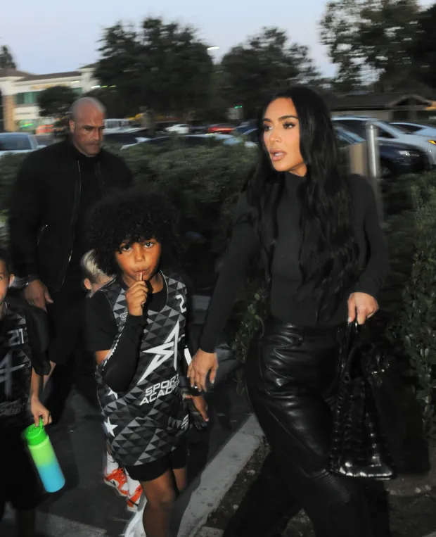 HOT MAMA! Kim Kardashian shows off famous curves in black skintight top and leather pants as she takes son Saint, 7, to soccer