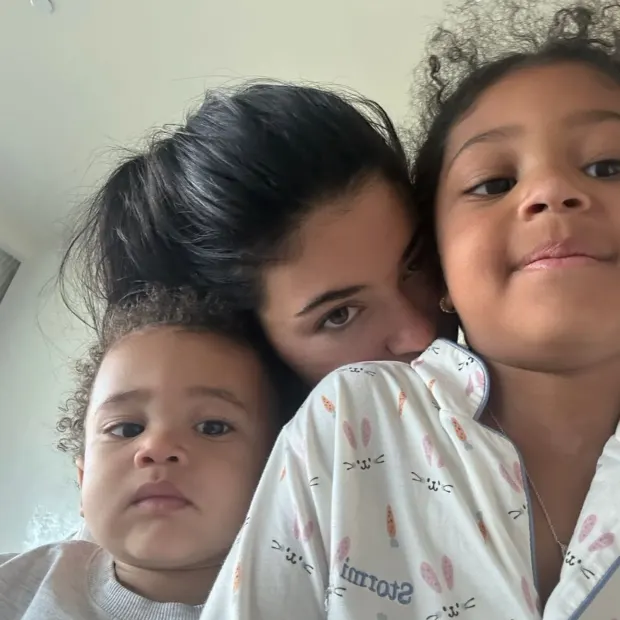 OH MY, KY! Kylie Jenner snaps ‘my back hurts!’ as daughter Stormi, 5, and niece True, 5, climb on her in new video