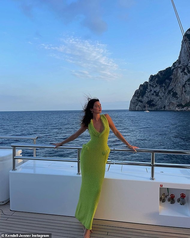 Kendall Jenner is a vision of luxury as she strikes poses on a yacht wearing chic neon green dress during getaway to Italy with boyfriend Devin Booker