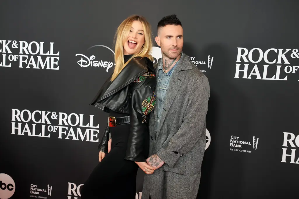 Behati Prinsloo awkwardly grabs Adam Levine’s hand on red carpet a year after overcoming cheating scandal