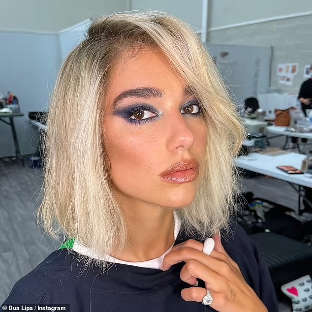 Dua Lipa switches her red locks for a choppy blonde wig as she shares behind the scenes snaps from Argylle film after her boozy New Year’s Eve