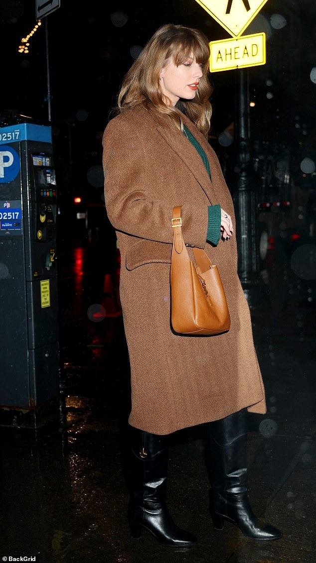 Taylor Swift shakes off the rain in a green sweater dress and chic brown coat and heads to the recording studio as storm batters NYC