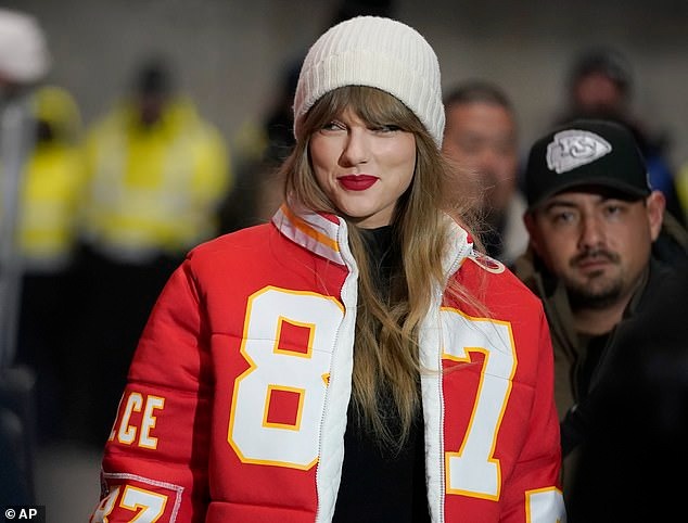 Taylor Swift waves at celebrating Chiefs fans as she watches Travis Kelce beat the Miami Dolphins in the NFL playoffs alongside his mom Donna amid reports they had a blazing row over Christmas