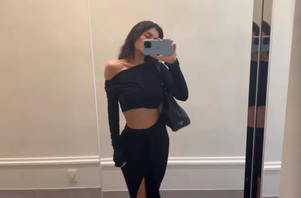 FLY KY Kylie Jenner shows off her tiny waist and shrinking ʙuтт in a black crop top and matching high-slit skirt